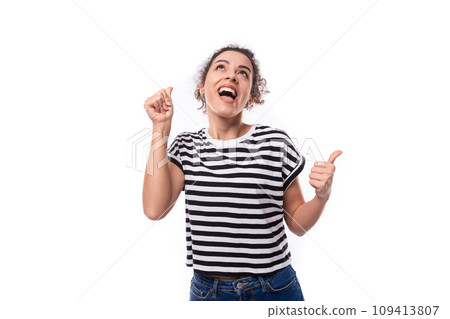a young caucasian woman with a curly haircut is dressed in a striped summer t-shirt enthusiastically a young caucasian woman with a curly haircut is dressed in a striped summer t-shirt enthusiastically 109413807
