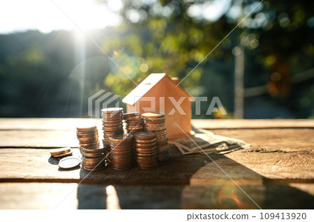 Saving money home, stacked money and savings house on the table 109413920