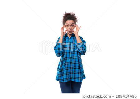 portrait of a slender young brunette woman in a loose-fitting blue plaid shirt portrait of a slender young brunette woman in a loose-fitting blue plaid shirt 109414486