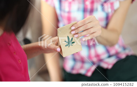 Marijuana leaf close-up on paper bag. Marijuana leaf close-up on paper bag. 109415282
