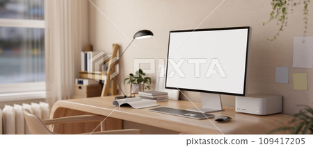 A white-screen desktop PC computer mockup on a modern wooden desk and decor in a minimalist room. 109417205