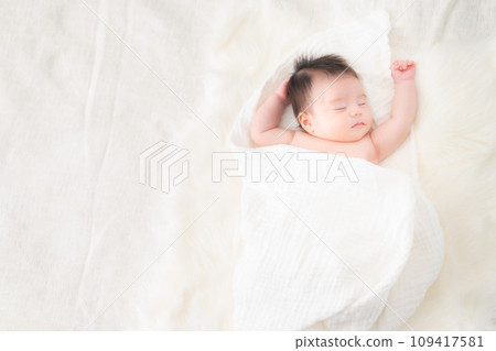 One month old boy sleeping wrapped 109417581