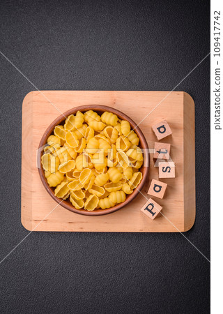 Raw durum wheat gnocchi pasta with salt and spices in a ceramic plate 109417742