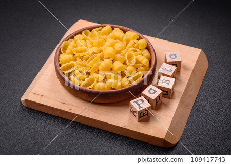 Raw durum wheat gnocchi pasta with salt and spices in a ceramic plate Raw durum wheat gnocchi pasta with salt and spices in a ceramic plate 109417743