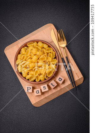 Raw durum wheat gnocchi pasta with salt and spices in a ceramic plate 109417755