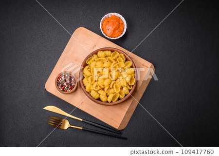 Raw durum wheat gnocchi pasta with salt and spices in a ceramic plate 109417760