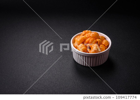 Delicious fresh pasta with pesto sauce, salt, spices and herbs on a ceramic plate 109417774