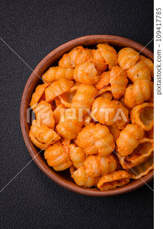 Delicious fresh pasta with pesto sauce, salt, spices and herbs on a ceramic plate Delicious fresh pasta with pesto sauce, salt, spices and herbs on a ceramic plate 109417785