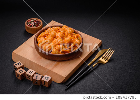 Delicious fresh pasta with pesto sauce, salt, spices and herbs on a ceramic plate Delicious fresh pasta with pesto sauce, salt, spices and herbs on a ceramic plate 109417793