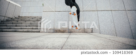Skateboarder skateboarding in modern city Skateboarder skateboarding in modern city 109418369