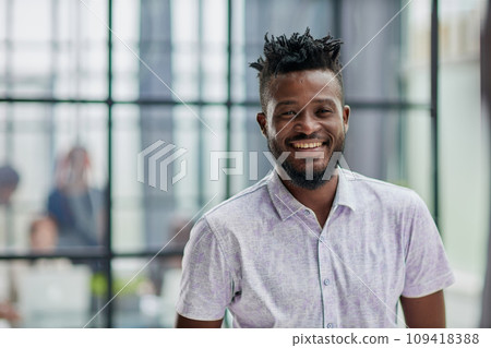Serious dark skinned businessman has strict look, contemplates about new business project 109418388