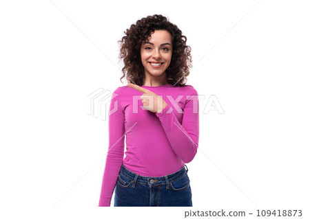 young curly brunette advertiser woman dressed in a lilac turtleneck points with her hand 109418873