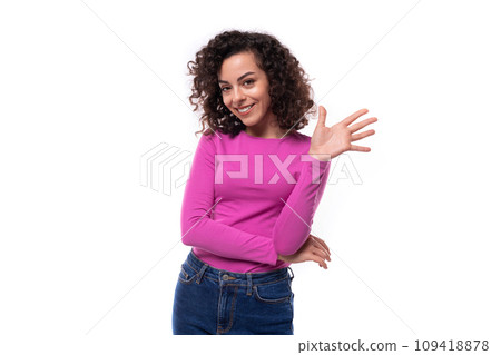 young authentic woman styling her hair with a curly method 109418878