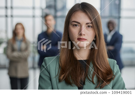 Portrait of a confident young businesswoman standing with her arms crossed in an office 109419001