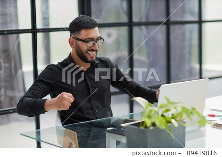 Business man sitting at his desk in the office Business man sitting at his desk in the office 109419016