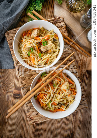 Fried noodles with chicken and vegetables. Fried noodles with chicken and vegetables. 109419043