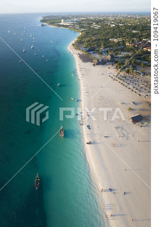 Panorama of shoreline at sandy beach and turquoise ocean at sunny day Panorama of shoreline at sandy beach and turquoise ocean at sunny day 109419067
