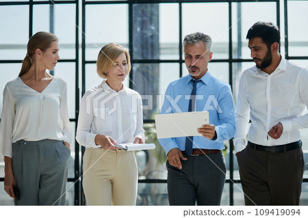Office routine. Female assistant manager discussing statistics with male chief executive officer. Office routine. Female assistant manager discussing statistics with male chief executive officer. 109419094