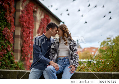 Young Cute Female Hugs Boyfriend. In Autumn Outdoor. Lovers Walking in Park. Attractive Funny Couple. Lovestory in Forest. Man and Woman. Cute Lovers in the Park. Family Concept. Happy Couple. 109419135