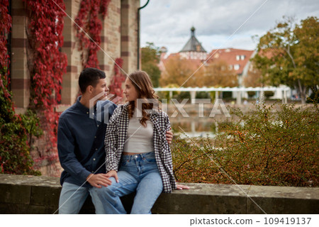 Young Cute Female Hugs Boyfriend. In Autumn Outdoor. Lovers Walking in Park. Attractive Funny Couple. Lovestory in Forest. Man and Woman. Cute Lovers in the Park. Family Concept. Happy Couple. 109419137