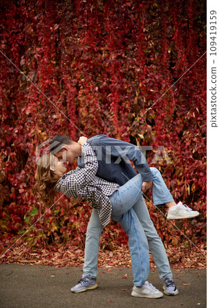 Young Cute Female Hugs Boyfriend. In Autumn Outdoor. Lovers Walking in Park. Attractive Funny Couple. Lovestory in Forest. Man and Woman. Cute Lovers in the Park. Family Concept. Happy Couple. 109419159