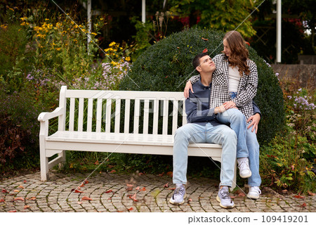 Young Cute Female Hugs Boyfriend. In Autumn Outdoor. Lovers Walking in Park. Attractive Funny Couple. Lovestory in Forest. Man and Woman. Cute Lovers in the Park. Family Concept. Happy Couple. 109419201