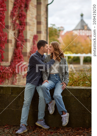 Young Cute Female Hugs Boyfriend. In Autumn Outdoor. Lovers Walking in Park. Attractive Funny Couple. Lovestory in Forest. Man and Woman. Cute Lovers in the Park. Family Concept. Happy Couple. 109419250