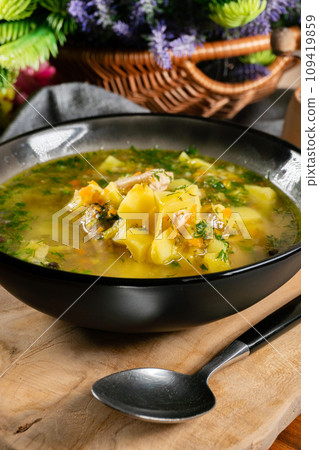 Cucumber soup in dark bowl. 109419859