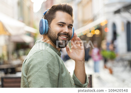 Rear view of young man tourist walking through the street outdoors, looking searching for a way 109420548