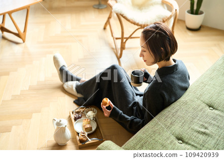 A woman slowly drinking tea 109420939