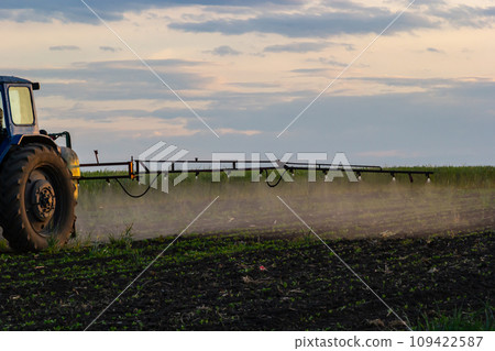 Tractor spraying pesticides on vegetable field with sprayer at spring Tractor spraying pesticides on vegetable field with sprayer at spring 109422587
