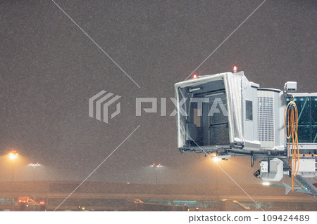 Winter frosty night at airport during heavy snowfall. Winter frosty night at airport during heavy snowfall. 109424489