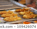 Closeup of Taiyaki Grilled Fish Cake with Cheese Filling - japanese food in the market, Vietnam 109426074