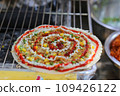 High angle view of grilled vietnamese pancake with eggs sausages and sauces in food festival 109426122