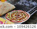 Closeup of grilled vietnamese pancake with eggs sausages and sauces in food festival 109426126