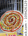 Colorful grilled vietnamese pancake with eggs sausages and sauces in the market 109426129