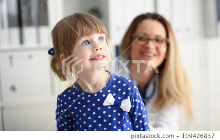 Little child with mother at pediatrician reception Little child with mother at pediatrician reception 109426837