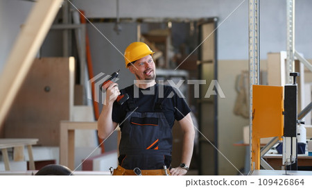 Idiot worker using electric drill portrait 109426864