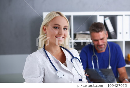 Beautiful smiling female doctor stand in office 109427053