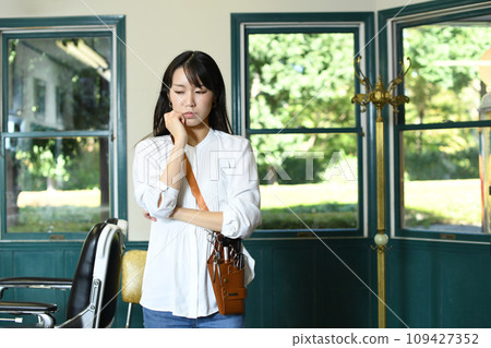 Asian hairdresser woman worried at beauty salon Asian hairdresser woman worried at beauty salon 109427352
