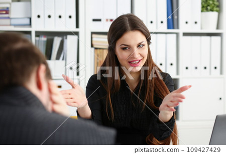 Man and smiling mature woman talking in office Man and smiling mature woman talking in office 109427429