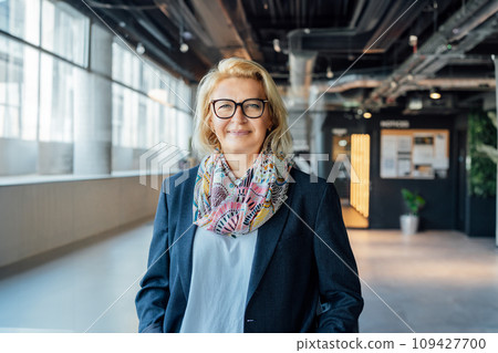 Portrait of smiling 50's stylish, confident mature businesswoman, middle aged company ceo director, experienced senior female professional, business coach team leader in modern office. Female leader. 109427700