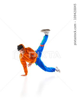 Young sportive man, dude wearing stylishly sport style cloth dancing breakdance elements, freezes against white background. Young sportive man, dude wearing stylishly sport style cloth dancing breakdance elements, freezes against white background. 109428845