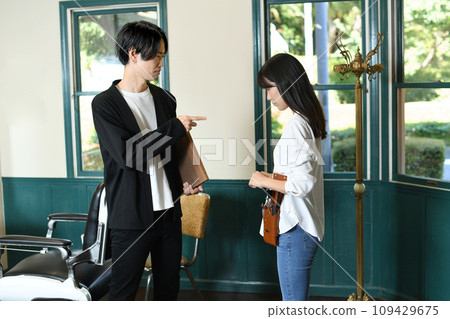 A female hairdresser gets scolded by a male hairdresser at a beauty salon A female hairdresser gets scolded by a male hairdresser at a beauty salon 109429675