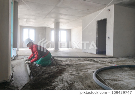 A builder in work clothes is doing his job 109429747