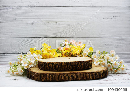 Wooden podium stand for product display with flower decoration on wooden background Wooden podium stand for product display with flower decoration on wooden background 109430066