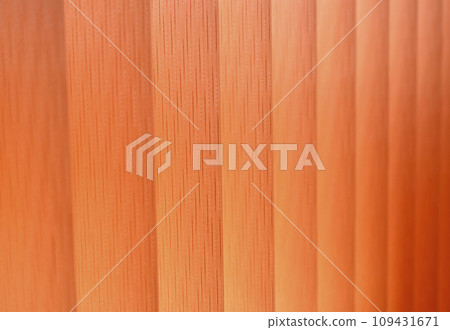 Background of vertical orange blinds curtains. Pleated roller blinds. Orange striped background. Background of vertical orange blinds curtains. Pleated roller blinds. Orange striped background. 109431671