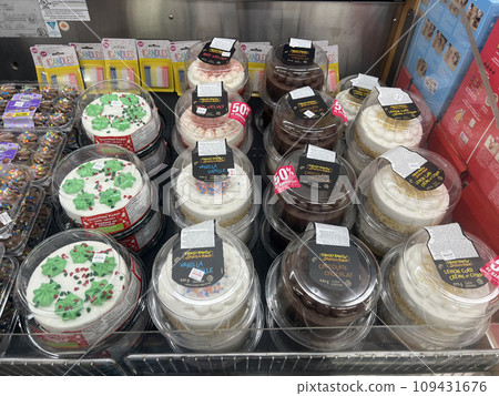 Delicious-looking colorful cakes lined up at discounted prices in the supermarket section Delicious-looking colorful cakes lined up at discounted prices in the supermarket section 109431676