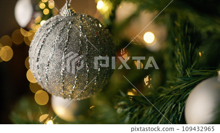 Silver ball on the branches of a christmas tree 109432965