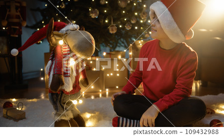 Child putting lights on a Christmas puppet 109432988